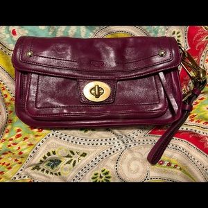 Authentic Raspberry leather Coach clutch with wrist strap. Large gold hardware.